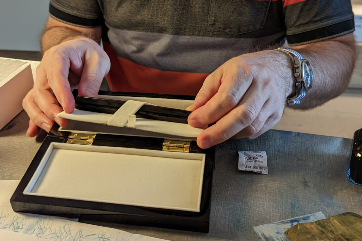 Taking out the pen from the piano black lacquered gift box