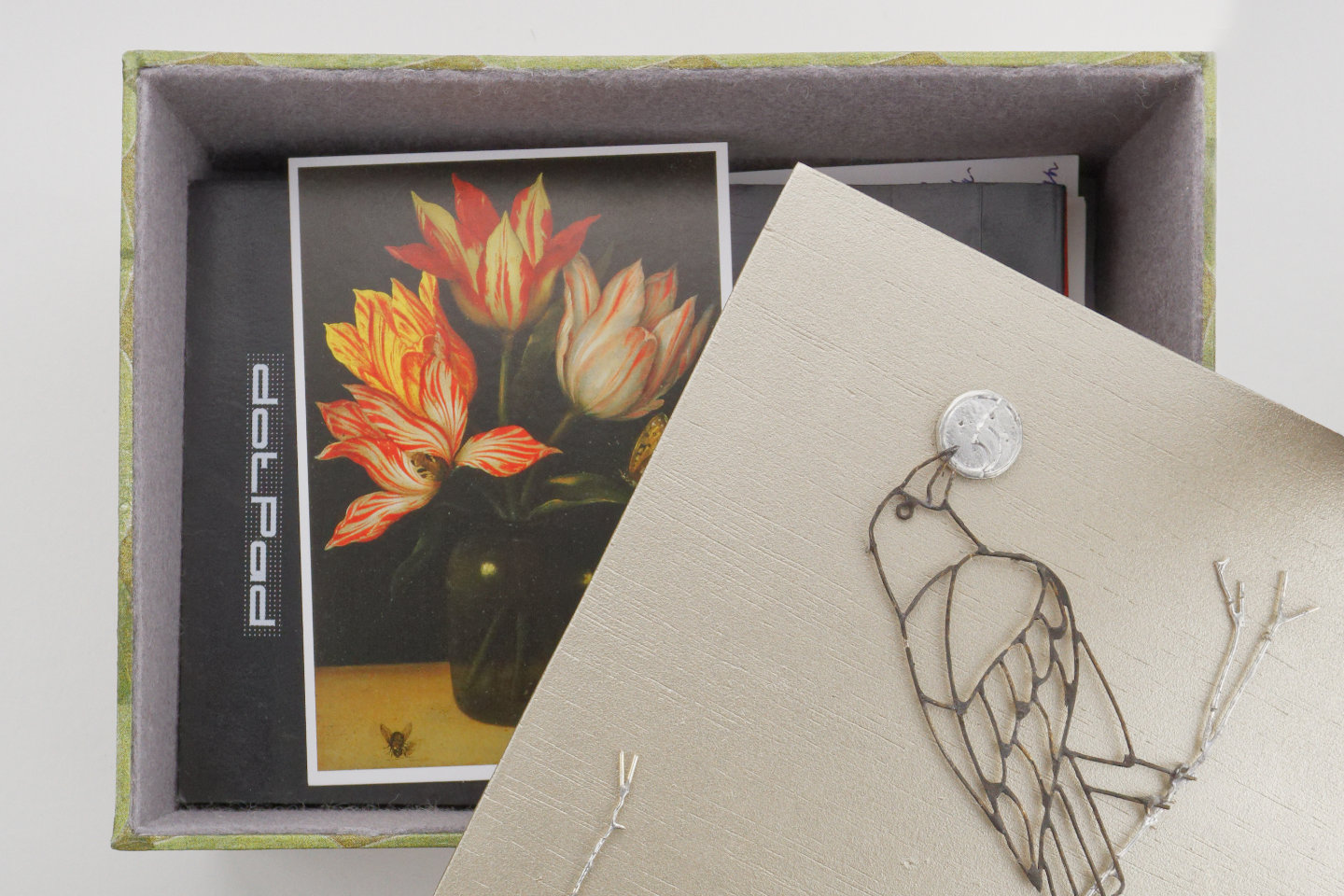 A postcard of Bosschaert’s Glass with four tulips inside